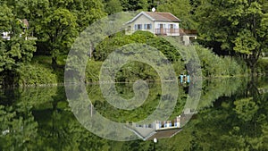 Reflection of a small rural house in water surface.