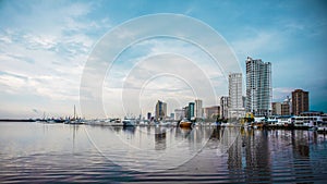 Reflection of seaside buildings in the setting sun