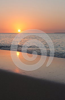 A reflection of the setting sun on the beach in Tonga
