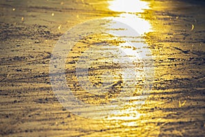 Reflection of the setting sun on the surface of the ice rink. Texture and backgrounds