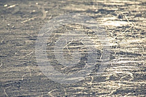 Reflection of the setting sun on the surface of the ice rink. Texture and backgrounds