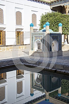 Monument reflecting in pool in courtyard, Mausoleum of Bahouddin Nakshband, Bakhara, Uzbekistan photo