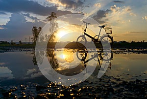 Reflection of Silhouette bicycle park on the waterfront