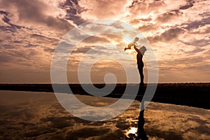 Reflection Silhouette of mother with her toddler against the sun