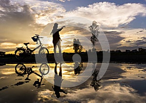 Reflection Silhouette of mother with her toddler against the sun