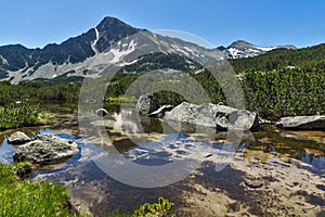 Reflection of Sivrya peak in Banski lakes, Pirin Mountain