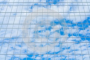 Reflection of the sky and clouds in the glass wall.