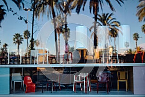 Reflection of the sky and palm trees in the window of a furniture store