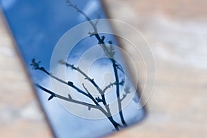 Reflection of the sky in the smartphone. Abstract background