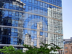 Reflection of a skyscraper in the glass facade of the building