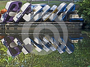 Reflection of stacked paddle boats
