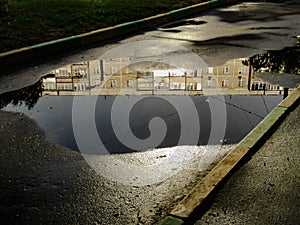 Reflection of a standard living block on the surface of a plash. photo