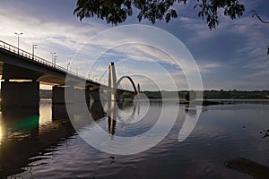 Reflection of the sun in the lake, bridge and islet photo