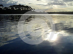 Reflection of the sun on the lake photo