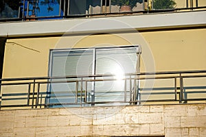 Reflection of sun in the large balcony window