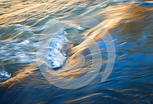 Reflection of the sun on the waves of the river