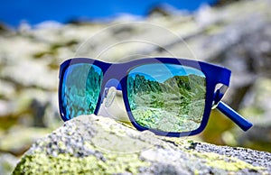 Reflection of mountains in sunglasses