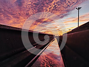 Reflection of the sunset in a piece of rail