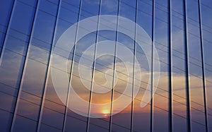 Reflection of sunset sky in metal wall