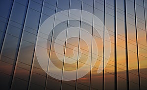 Reflection of sunset sky in metal wall of office