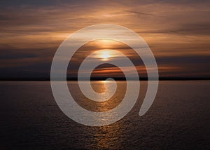 The reflection of the sunset in the water of Pegwell Bay, Kent UK