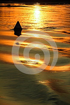 Reflection of the sunset on the watery surface.