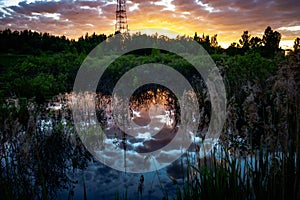 Reflection of a television tower in the surface of the lake