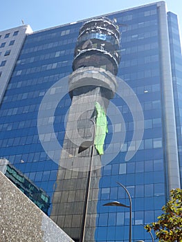 Reflection of a tower in a glass facede of a modern building