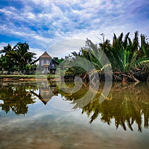 Reflection of traditional Malay house in the river in Terengganu Malaysia