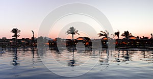 Reflection of trees and bildings in the water surface.
