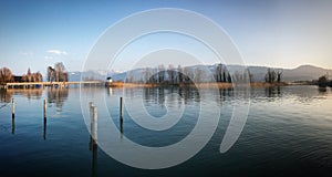 Reflection of trees in the mountain lake in Switzerland, March 2019