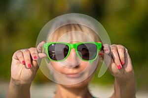 Reflection of tropical resort beach in sunglasses