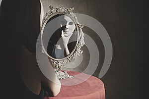 reflection of a vain woman with mask in front of the mirror, identity concept