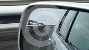 Reflection view of road in side rearview mirror of a car