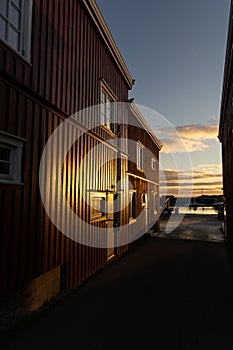 Reflection of warm sunrise in facade of fishermen\'s hut at HamnÃ¸y, Lofoten, Norway photo