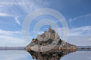 Reflection on the water of abbey of Monte Saint Michel in Northern France photo