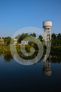 Reflection of the water tank in the pond water