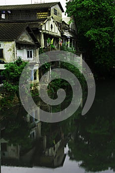 Reflection white old houses in the river in Thailand