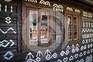 Reflection in windows on ornament cottage in village Cicmany, Slovakia