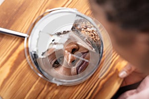 Reflection Of A Woman`s Face In Broken Mirror