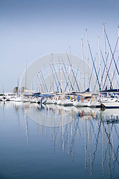 Reflection of yacht masts in the water