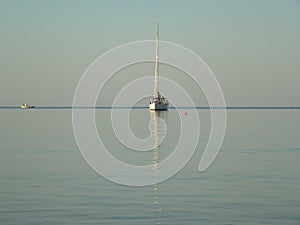 Reflection of a yacht in the sea.