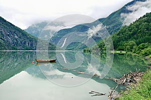 Reflections of Asafossen waterfall in Eide Lake