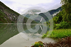 Reflections of Asafossen waterffall in Eide Lake