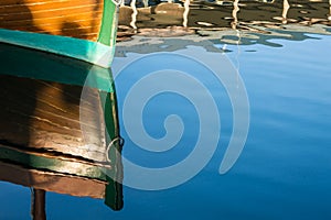 Reflections of a beautiful wood boat.