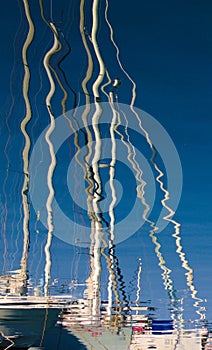 Reflections of boats in the sea.