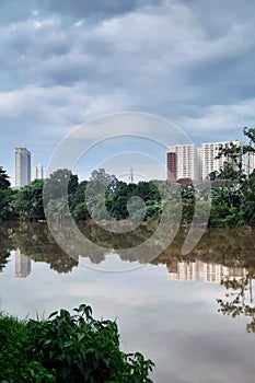 Reflections of buildings and trees on the Cisadane River, Tangerang City, decorated with beautiful clouds. photo