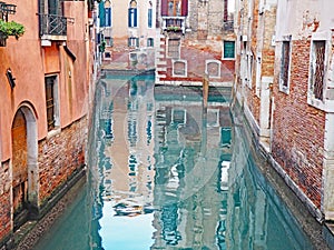 Reflections in a canal in the city of Venice, Italy