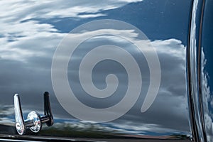 Reflections of the clouds, classic car trunk
