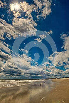 Reflections of clouds in the edge of the surf.